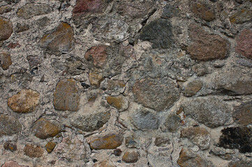 stone wall, in the photo an old stone wall made of large stones