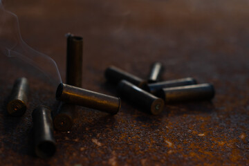 smoking spent cartridge cases from a hunting rifle, murder, danger, war