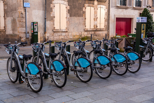 Velo Plus rental bikes parked in a street station in Orleans, France