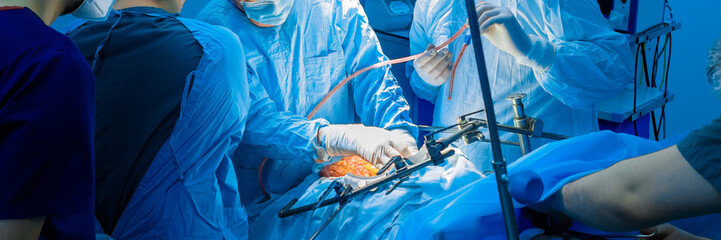 Teamwork of surgeons during surgical treatment of a patient. Selective focus. Panoramic photo. Medical concept.