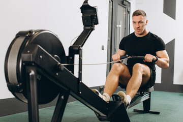 Man running rowing excercise in the gym © anatoliycherkas