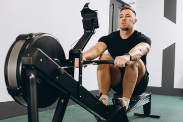 Man running rowing excercise in the gym © anatoliycherkas