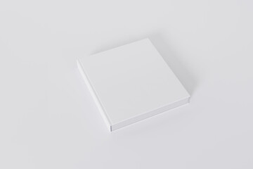 Mockup of a square book with a blank glossy white cover on white background. Isolated with clipping path.