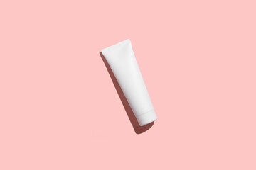 Cosmetic White Plastic Tube Isolated on pink background. Mock Up.