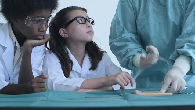 Education concept of 4k Resolution. Medical school students practicing suturing wounds in classroom. internship doctor. training simulation.