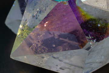 Colourful Angel Aura Quartz crystal point cluster on black surface