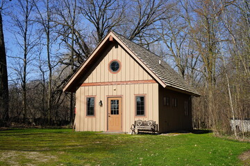 Obraz premium Historical old vintage abandoned mini stone church stands enclosed around a forest out in the countryside