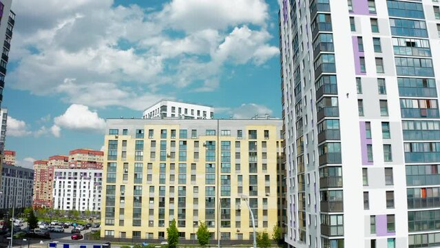 A sunny daytime exterior of a typical upscale apartment building. Stock footage. Aerial view of a summer city street with beautiful buildings.