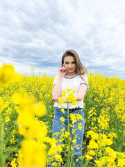 Naklejka na ściany i meble Lovely young woman in bright yellow field