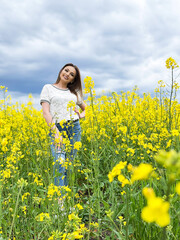 Obraz na płótnie Canvas Lovely young woman in bright yellow field