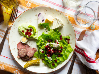 Appetizing Albanian appetizers of light vegetable salad, a mix of djatrash and Salсe Kosi sauce - obrazy, fototapety, plakaty