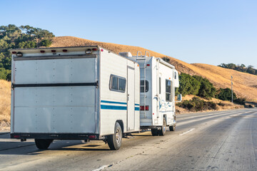 RV towing a large trailer on a highway in East San Francisco Bay, California