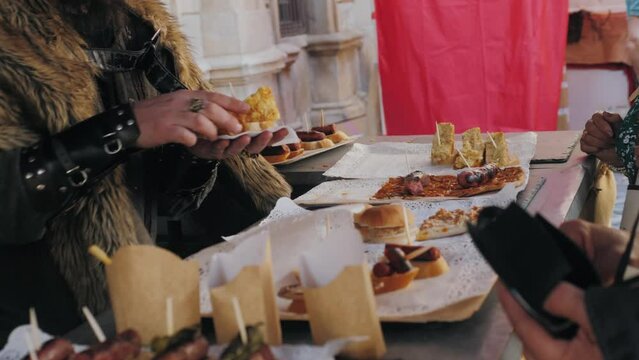 Spanish tapas, pintxos, sandwich, basque cuisine, wine snack. Traditional medieval barbecue, catalan sausages, grill BBQ medieval style, fried meat food.