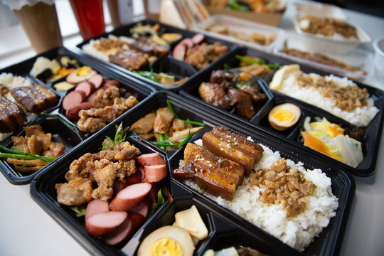 Taiwanese bento box delivery takeaway ready to go, sets of braised pork, Taiwanese sausage, fried chicken, braised pork rice, Lu Rou Fan combo