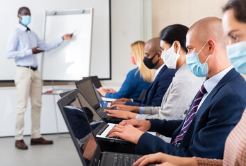 international group of managers with laptop in advanced training courses during epidemic