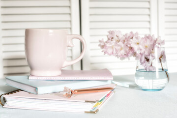 Notebooks notepads and coffee. bright workplace.