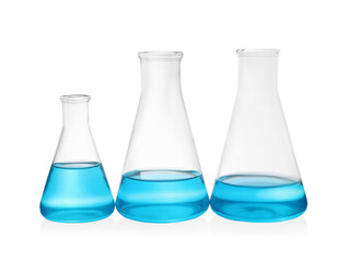 Different laboratory glassware with light blue liquid on white background