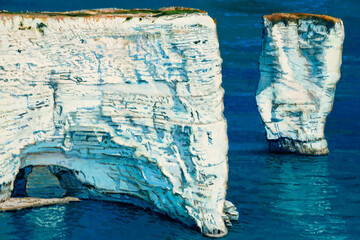 Detail of oil painting depicting chalk cliffs of Etretat Normandy in France with the natural arch Porte d`Aval and the stone needle called L`Aiguille.