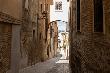 Narrow streets of old town of Toledo, Castilla-La Mancha, Spain. - obrazy, fototapety, plakaty