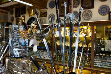 Various handcrafted swords and daggers displayed in artisan shop of Toledo. Traditional travel...