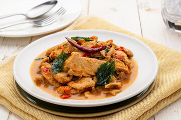 Pad kra pao gai, chicken stir-fried with chili, garlic and holy basil leaves to create this hot-spicy delicious dish. It is a popular simple Thai menu served from street food carts to restaurants. - obrazy, fototapety, plakaty