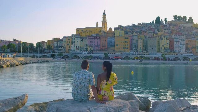 Menton France,couple men and woman on vacation at the Cote d Azur France, View on old part of Menton, Provence-Alpes-Cote d'Azur, France Europe