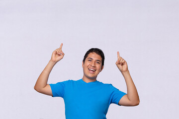 hispanic man pointing up at something blue shirt white background