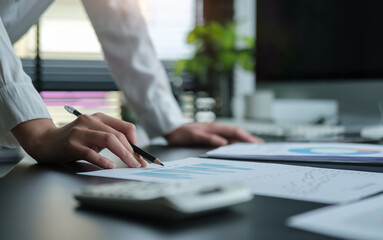 Fototapeta premium A young female administrative assistant making notes of working planning organizing information in her office..