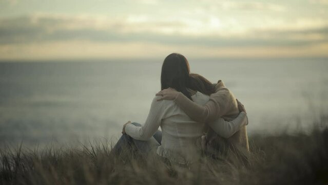 comforting friendly hug friends hugging empathy compassion sunset slow motion