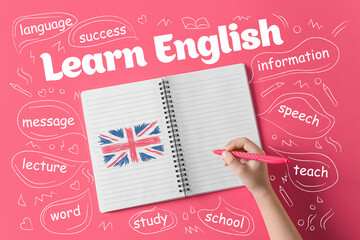 Child's hand drawing flag of Great Britain in notebook. Learn English