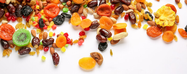 Different dried fruits and nuts on white background