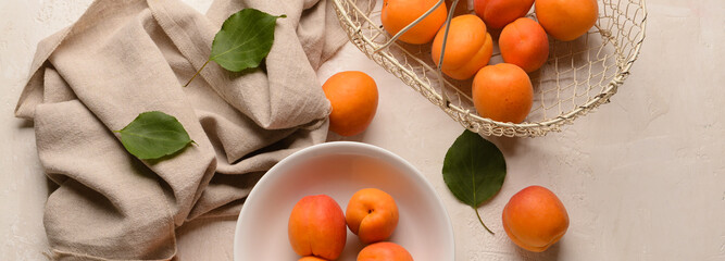 Composition with tasty ripe apricots on light background