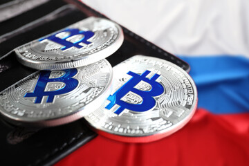 Wallet with bitcoins on national flag of Russian Federation