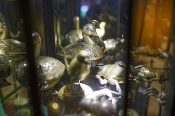 brass vase in glass cabinet
