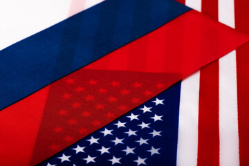 Fragments of the US and Russian Federation flags lying on top of each other