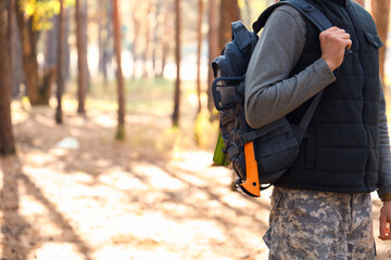 Fototapeta premium Male tourist with backpack in forest