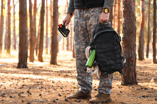 Male tourist with survival kit in forest
