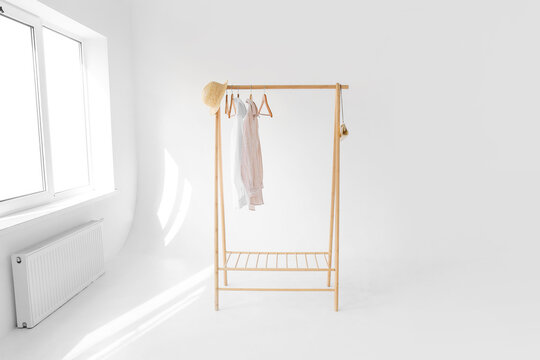 Wooden rack with shirts and accessories in modern photo studio