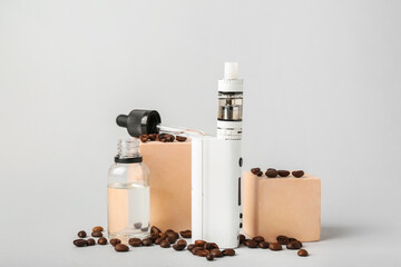Modern vape mod, oil and coffee beans on grey background