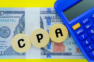 calculator, money and a round stick with the letters CPA or the word the word Cost Per Action