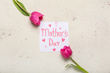Card with text MOTHER'S DAY and pink tulips on light background