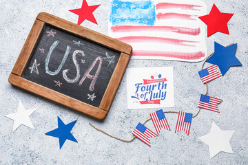 Fototapeta na wymiar Greeting card for Independence Day, chalkboard and USA flags on grunge background