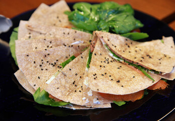Salmon sandwiches with vegetables on the plate.