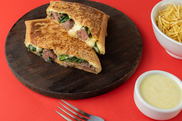 Swiss Crepe stuffed with arugula and filet mignon, Straw Potatoes and Béchamel Sauce