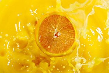 Closeup of splashing orange juice, top view. Splash of fresh sweet orange, mango, fruit juice....