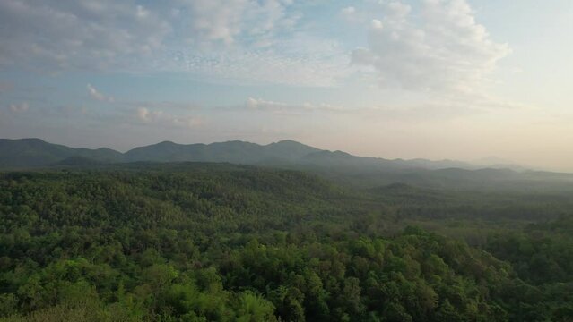 Aerial landscape view of greenery rainforest mountains before sunrise by drone