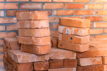 Red ceramic bricks stacked close up at a construction site. building materials