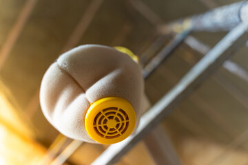 Yellow respirator half mask hanging on scaffolding, bottom view