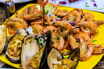 Tasty prawns and mussels in plate in restaurant