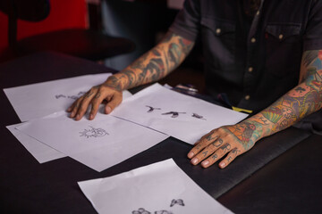 Tattoo art on body. Close up of tattoo artist in tattoo studio. Tattooing concepts.